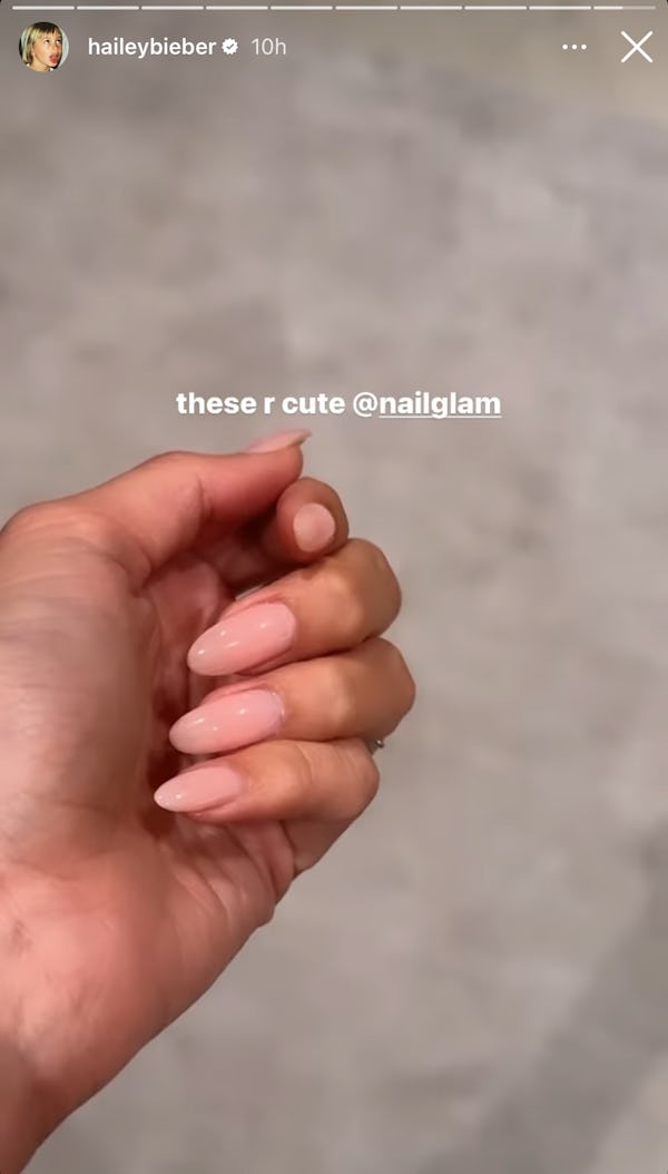 Hailey Bieber's lip gloss nails have a soft, rounded almond shape. Dawn Sterling is the manicurist b...