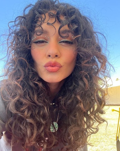 Vanessa Hudgens face gem festival makeup and curly hair Coachella 2022