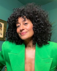 Tracee Ellis Ross fluffy curls with curly bangs and green blazer