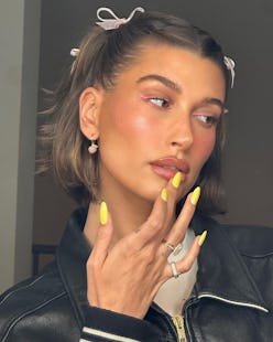 Hailey Bieber bright yellow nails and hair bows