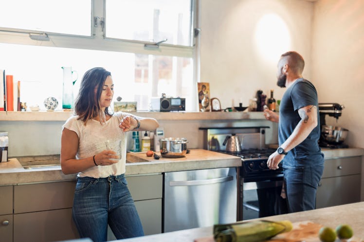 Woman worried about being late checks watch beside husband