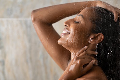 woman showering and smiling