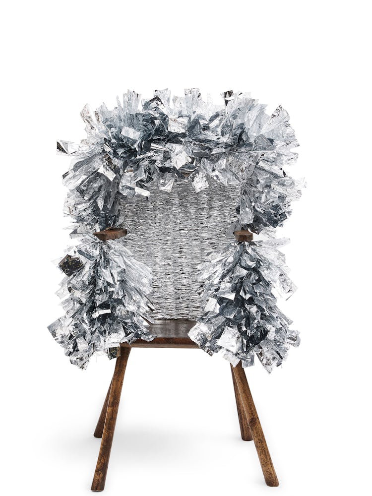 a wooden stick chair wrapped in tinsel