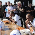 LeSean McCoy and Chad "Ochocinco" Johnson compete in the Celebrity Spicy Wing Challenge as Guy Fieri...