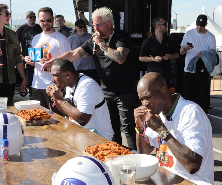 LeSean McCoy and Chad "Ochocinco" Johnson compete in the Celebrity Spicy Wing Challenge as Guy Fieri...