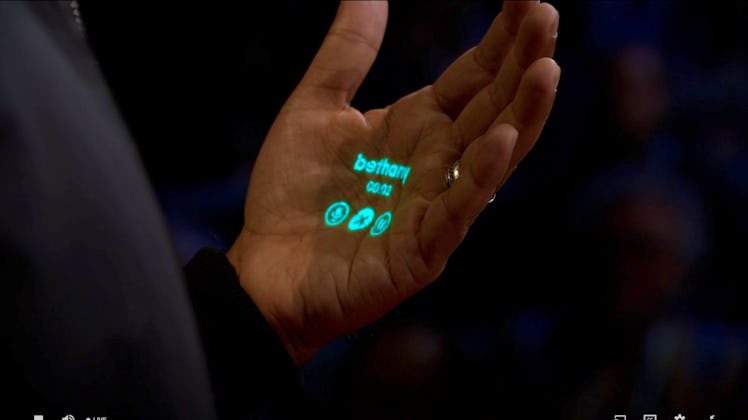Humane founder Imran Chaudhri demonstrating its AI-powered wearable projector at a Ted2023 talk by t...