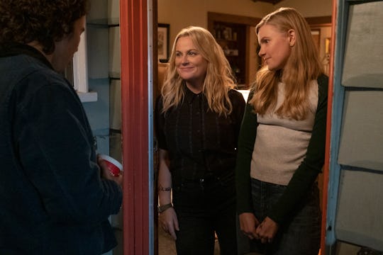 Nico Hiraga as Seth, Amy Poehler as Lisa, Hadley Robinson as Vivian stand in a doorway in 'Moxie,' a...