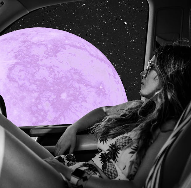 Young woman looking at the purple moon after reading her May 2023 horoscope.