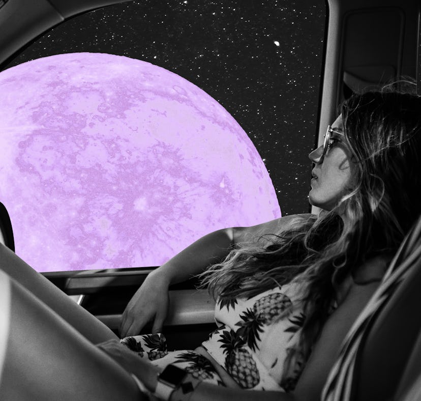 Young woman looking at the purple moon after reading her May 2023 horoscope.