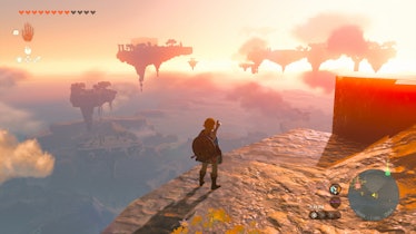 Link stands on a sky island in pink twilight.