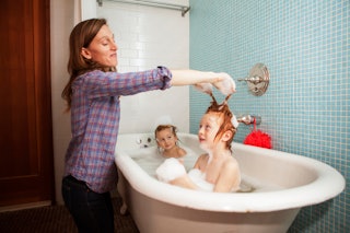 A mom bathes her kids
