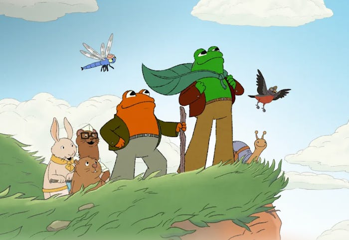 The characters of 'Frog and Toad' stand triumphantly on the edge of a cliff.