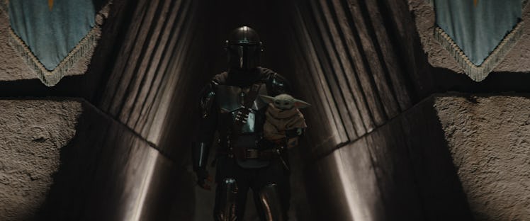 Din Djarin (Pedro Pascal) holds Grogu in The Mandalorian Season 3 Episode 8