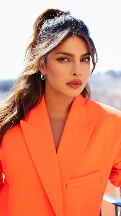 Priyanka Chopra half ponytail and orange suit