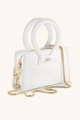 the new luar and mejuri bag in white with a gold chain strap