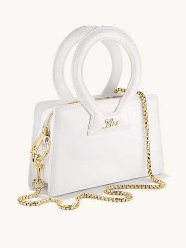 the new luar and mejuri bag in white with a gold chain strap