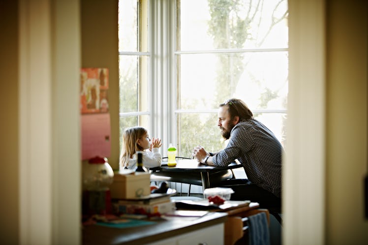 Father and daughter sitting at breakfast table