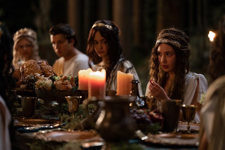 The Yellowjackets teenagers wear Roman garb around a dinner table in Season 2 Episode 2