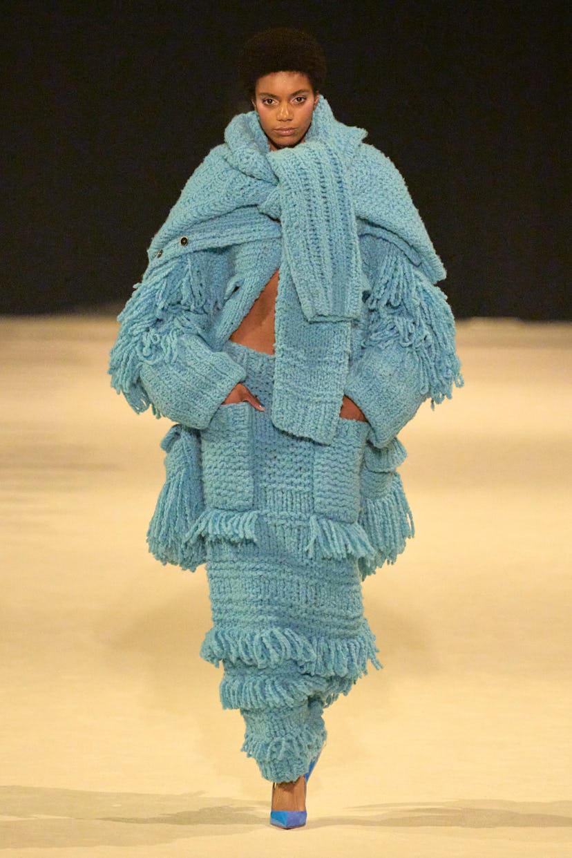 A look from Christopger John Rogers' resort 2024 show. A model wears a blue, full knit look