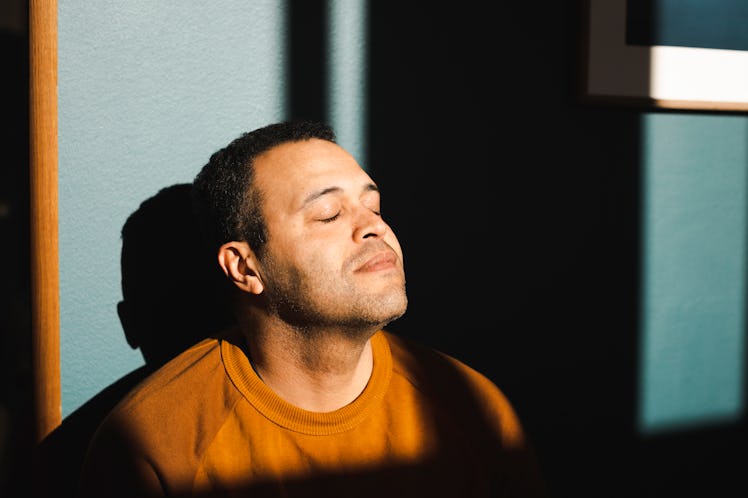 Man closing his eyes and trying to be calm
