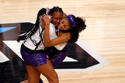 Angel Reese #10 of the LSU Lady Tigers celebrates with a teammate after defeating the Iowa Hawkeyes ...