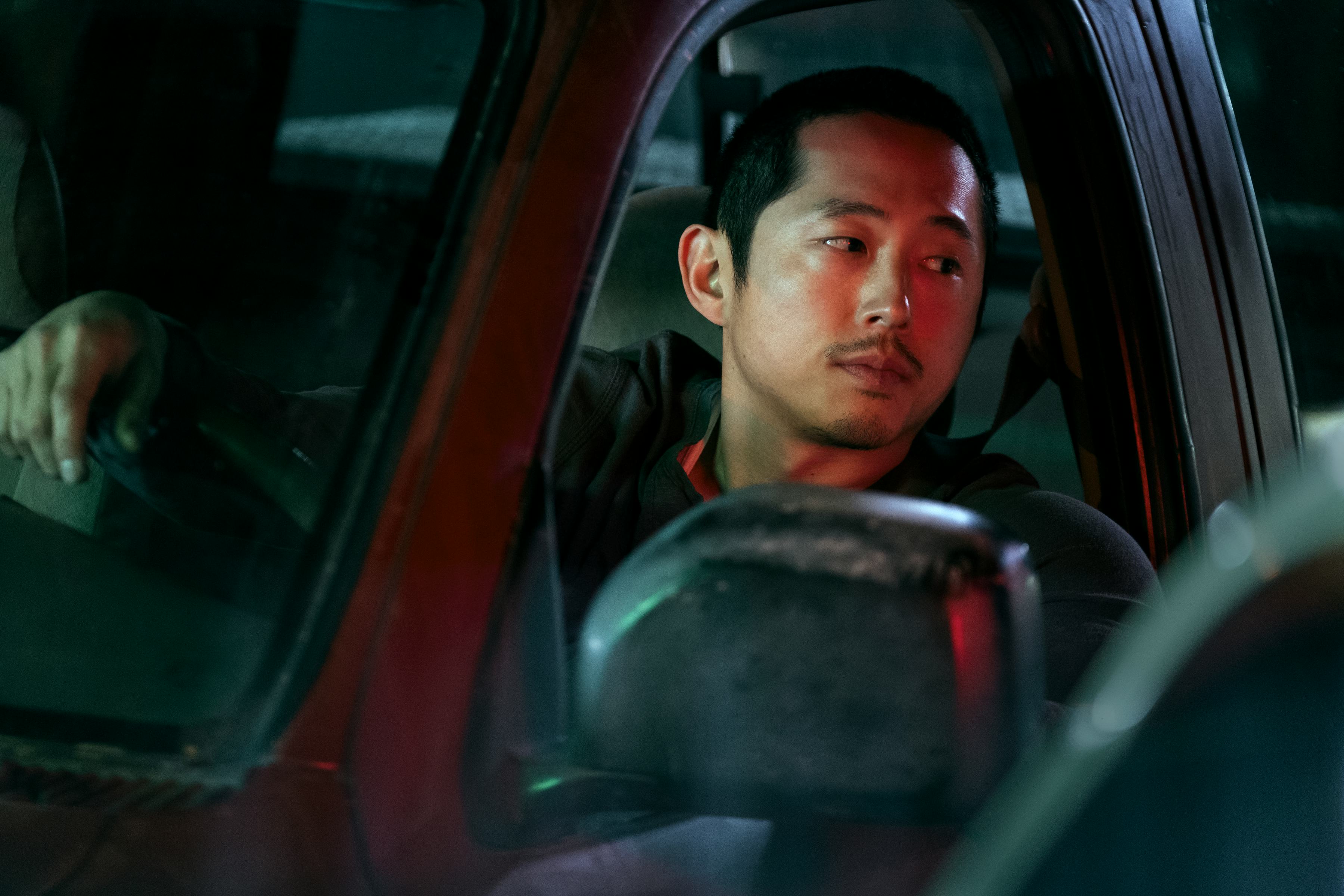 Danny (Steven Yeun) in his car looking at Amy (Ali Wong) in &lsquo;BEEF.'