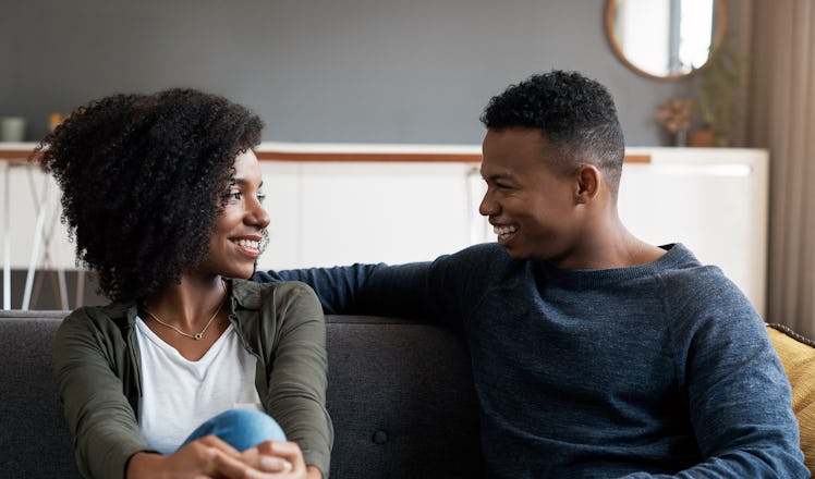 Husband and wife on couch having intimate conversation