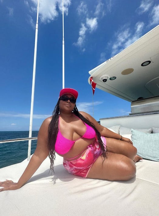 Lizzo lounges on a yacht in a pink Good American bikini. 