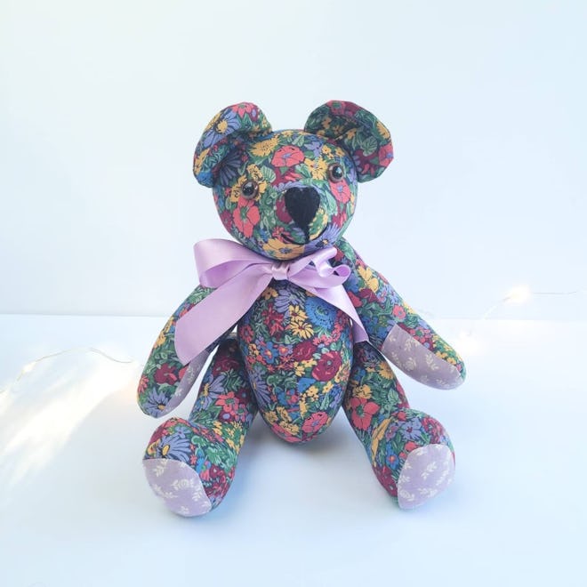 Handmade teddy bear with dark colored liberty fabric, maroon, blue, yellow, and purple