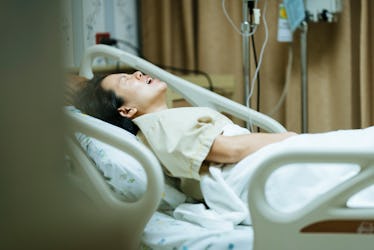 A woman giving birth in a hospital bed.