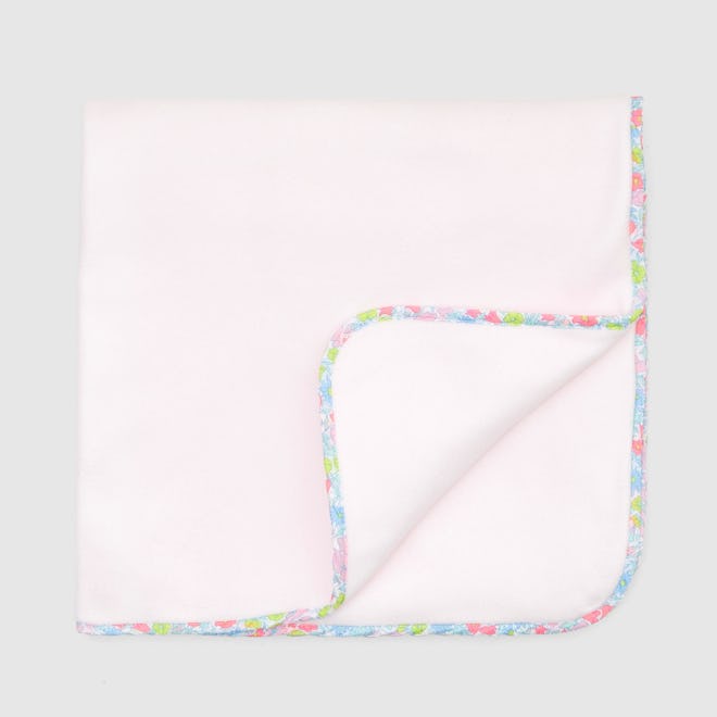 Light pink fleece and colorful Liberty floral blanket 