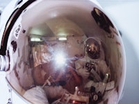 Three of the STS-6 astronaut crew in the airlock of Earth-orbiting space shuttle Challenger, where A...