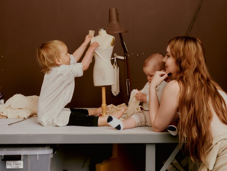 Fashion designer Elena Velez at her design studio with her children Atlas, 2, and baby Freja Lucia.