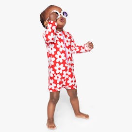 Baby swimsuits, like this red rash guard with white flower print, that are new for the summer