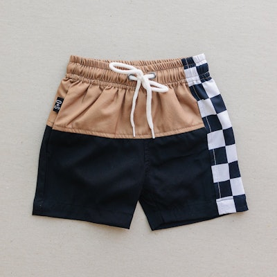Toddler swimsuit trunks with beige, black, and checkered color blocking