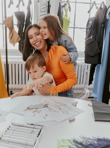 Fashion Designer Michelle Ochs with her two children in her design studio.