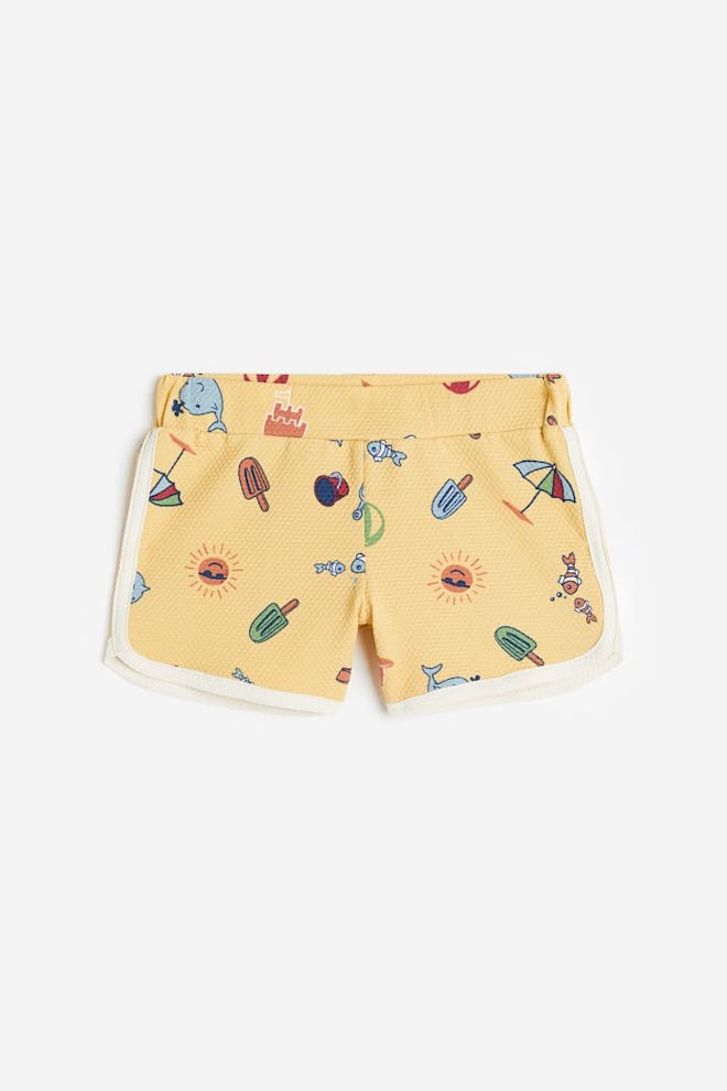 Yellow toddler swimsuit trunks in short retro inseam