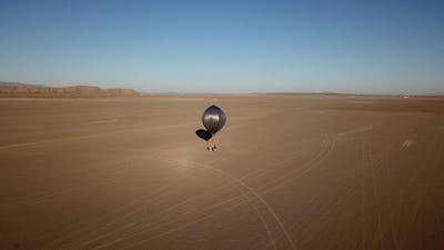 A shiny balloon in the desert