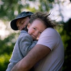 A son and dad hugging outside.