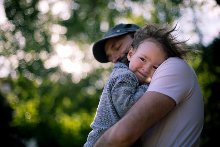 A son and dad hugging outside.