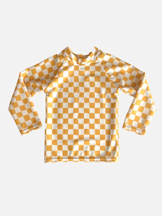 Toddler swimsuits include this yellow check rash guard with long sleeves