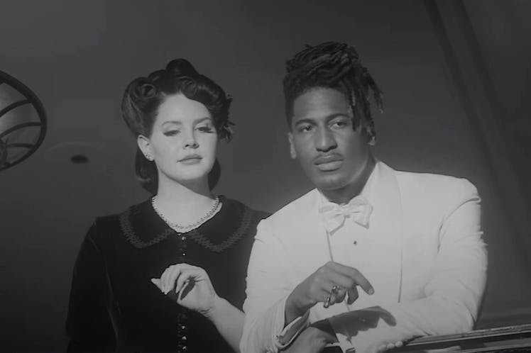 Lana Del Rey and Jon Batiste in the "Candy Necklace" music video.