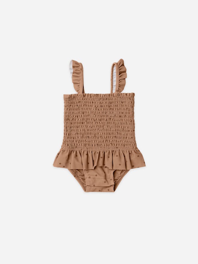 Baby swimsuit, a one-piece in brown with polkadots and a ruffle