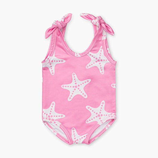 Toddler swimsuit, a pink one-piece with white starfish front and bow straps