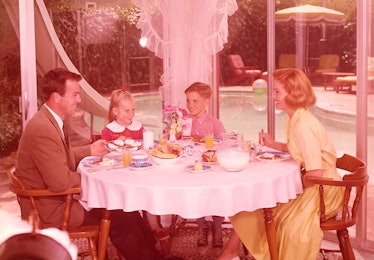 1950s family sitting around a table eating breakfast