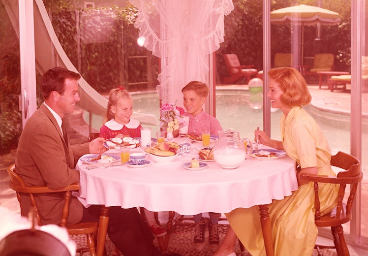1950s family sitting around a table eating breakfast