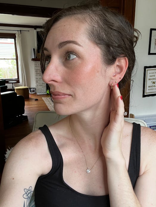 Author wearing the product in a Saie Glowy Super Gel Lightweight Dewy Highlighter review.