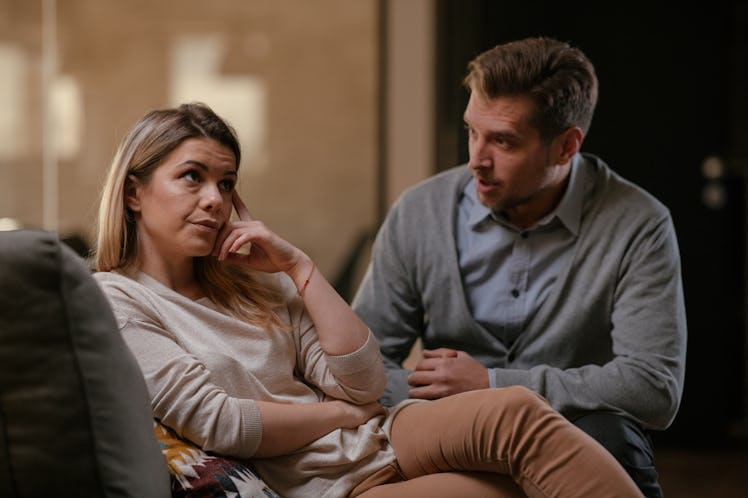 Middle aged husband and wife having an argument in their living room
