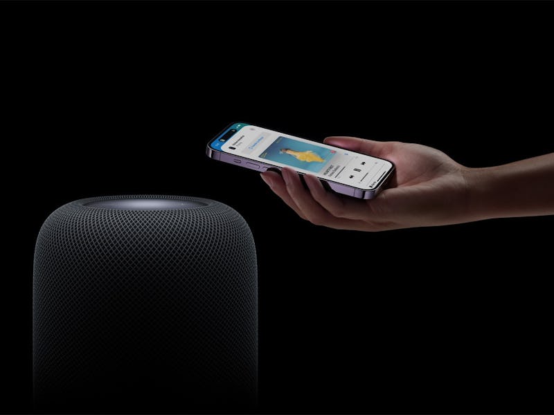 An iPhone over a HomePod smart speaker