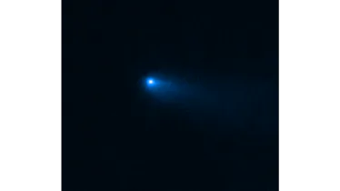 A bright dot is surrounded by a haze that slightly trails to the side. This is an image of Comet Rea...